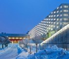 Stockholm International Fairs is a Woven Silver Building with Living Green Walls on the Inside