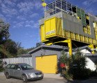 Ecotech Gives a 1950s Bungalow a Bright Yellow Shipping Container Addition