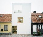 Stark White Townhouse in Sweden Stands in Defiant Contrast with Its Stoic Neighbors