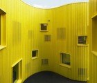 Curvy Tellus Nursery School is Wrapped in a Canary-Colored Pine Facade