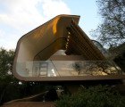 C-Shaped Wright House Extension Gives Thatched Roofing a Modern Twist