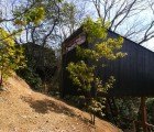 Tiny Charcoal-Colored Hut by Koji Kakiuchi Creates a Corridor to Nature