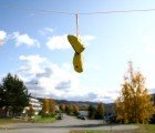 Shoe-Shaped Wooden Birdhouses Hang Over Urban Power Lines Like Sneakers