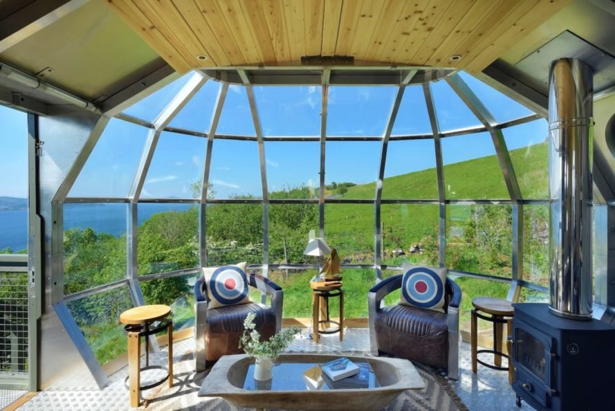a domed glass wall with seating on the interior
