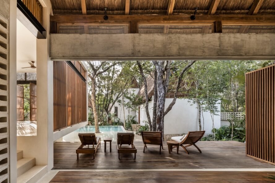 wood chairs on a wood patio by a pool