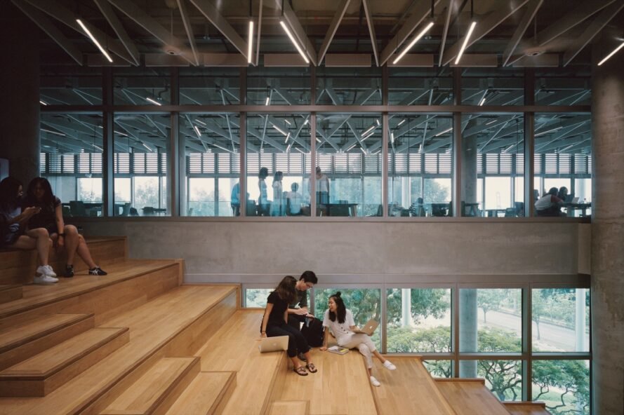 students sit on wood stairs