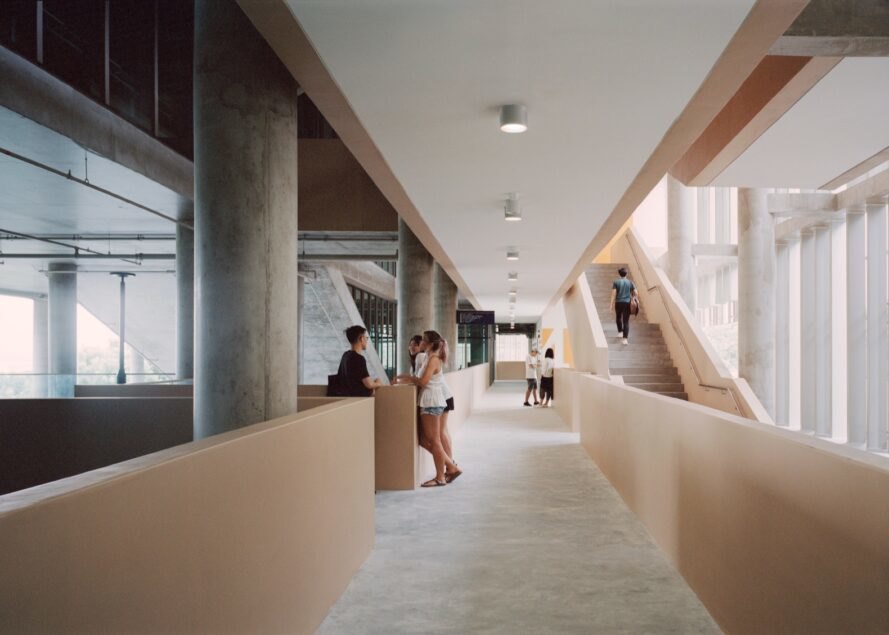 interior of building with students walking through hallways and stairwells