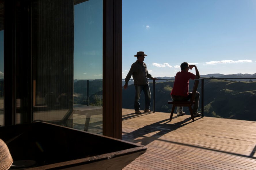 two people sitting on a large wooden deck
