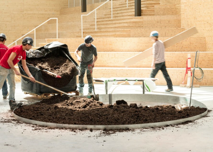 men working on round planting area