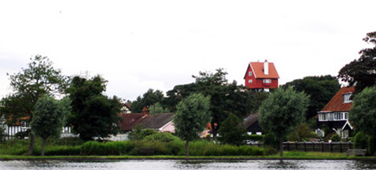 The "House in the Clouds" in Thorpeness, Suffolk, England is an old water tower converted into a home and later a bed & breakfast, water tower house, adaptive reuse, industrial conversion space, water tower home, house in the clouds, sky-high house, Thorpeness, Suffolk, England, bed and breakfast, bed & breakfast, green design, eco design, green building,