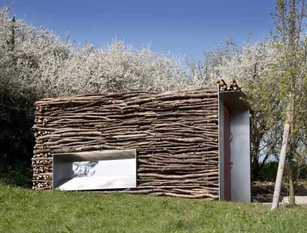 A Stack of Sticks Conceals This Modern German Restroom