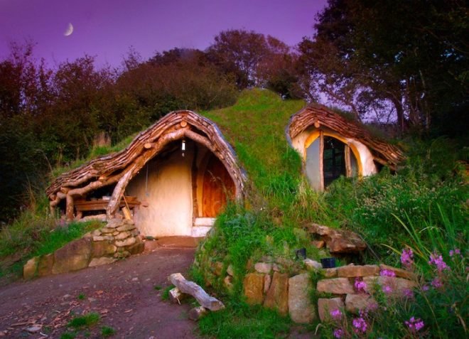 grass-covered home with arched doorway