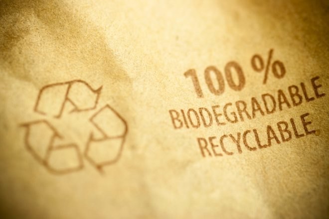 A brown package that reads "100 percent biodegradable recyclable"