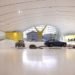 Enzo Ferrari Museum showroom, Ferarri, italy, cars, automobile, yellow, modern, photovoltaic, geothermal, flashy, bold, windows, energy savings, funky