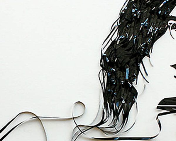 A portrait of John Lennon made out of casette tape.