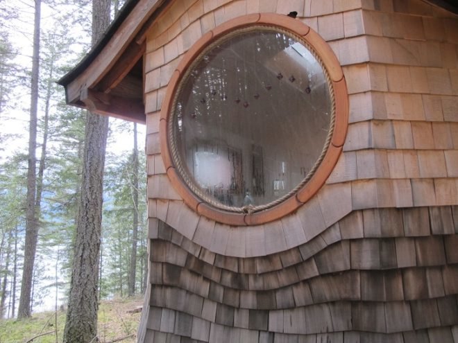 round window, curved roof, house in the woods, handsplit shingles