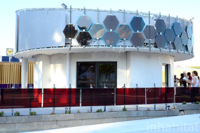 [gallery_extend] Solar Decathlon Casa PI by team Unizar is the only project at Madrid's Villa Solar that boasts a circular structure and an elevator, and it is also only one of two homes that has been sold. Although the original solar-powered design did not call for an elevator, the home's new owner asked for one to be installed, putting the team's real-world flexibility to the test. This addition has caused some complications that have delayed completion, but the challenge has created an indispensable learning experience for the team, which is currently in second-to-last place. Let's put the elevator aside for a moment in order to recognize the value of Unizar's unique Casa PI home, which relies on geometry to reduce overall surface size and therefore slash the home's energy consumption. Using Glass Reinforced Concrete (GRC) to ensure optimum thermal performance, the Spanish team was also able to increase the project's energy efficiency. This combined with a unique energy-generating photovoltaic wall surrounding the home's exterior perimeter contributes to a self-sufficient and portable dwelling. Albeit unfinished, we were impressed with Casa PI's interior layout, which maximizes space. One half of the house has a living room cum study area, the kitchen occupies a slice in between this and the main bedroom, while a small private bathroom completes the home's practical requirements. Although Casa PI definitely needs some work, we applaud the team's remarkable perseverance. + Casa PI by UNIZAR + Solar Decathlon Europe Coverage on Inhabitat [gallery]