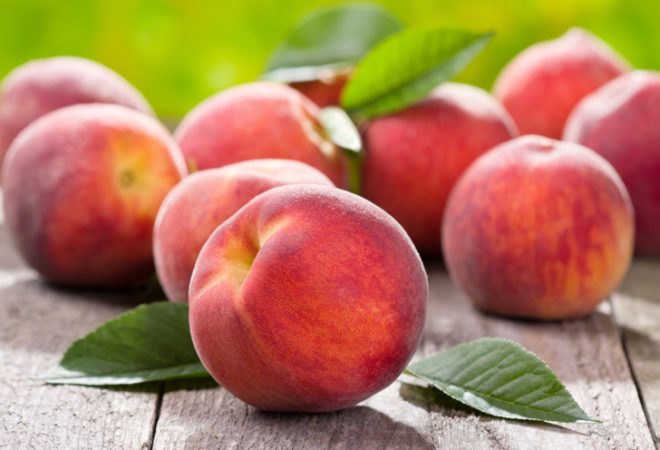 fresh peaches on wood table
