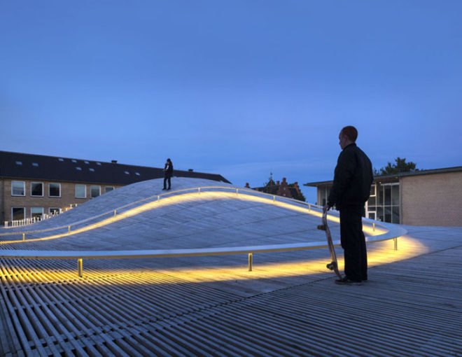 BIG, underground facility, form follows function, retrofit architecture, courtyard, custom benches, LED lighting, solar panels, underground architecture, organic courtyard