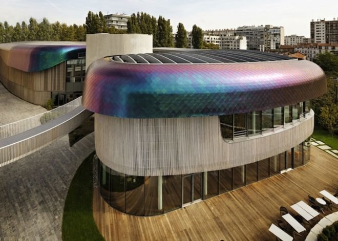 Agence Jouin Manku, office space, amenities wing, Société Foncière Lyonnaise, IN/OUT, iridescent shingles, stainless steel tiles, glass pavilion, bush hammered concrete, contemporary architecture, avant garde architecture