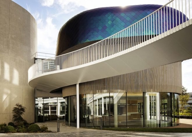 Agence Jouin Manku, office space, amenities wing, Société Foncière Lyonnaise, IN/OUT, iridescent shingles, stainless steel tiles, glass pavilion, bush hammered concrete, contemporary architecture, avant garde architecture
