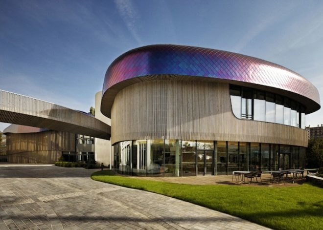 Agence Jouin Manku, office space, amenities wing, Société Foncière Lyonnaise, IN/OUT, iridescent shingles, stainless steel tiles, glass pavilion, bush hammered concrete, contemporary architecture, avant garde architecture