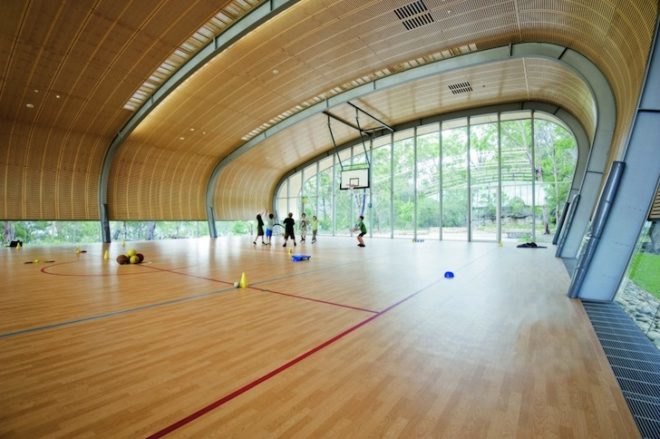 Milson Island Indoor Sports Stadium, canoe-inspired, Allen Jack+Cottier Architects, sydney, sports stadium, sports hall, multipurpose hall, plywood ceiling, arched frame, wind turbines, campsite, youth retreat, rainwater collection, rock garden