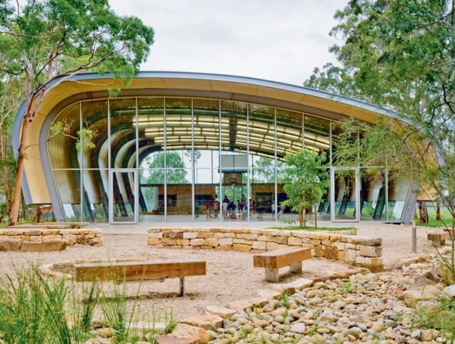 Milson Island Indoor Sports Stadium, canoe-inspired, Allen Jack+Cottier Architects, sydney, sports stadium, sports hall, multipurpose hall, plywood ceiling, arched frame, wind turbines, campsite, youth retreat, rainwater collection, rock garden