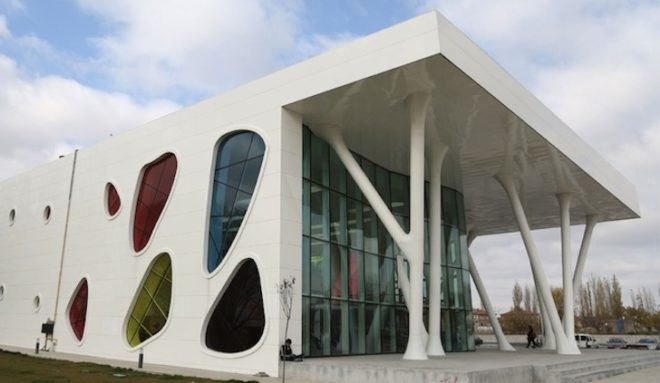 Bahadir Kul Architects, kayseri ice rink, ice rink, blob-shaped windows, turkey, kayseri, anatolian wonderland, tourism hub, mezzanine level, colorful windows, futuristic facade