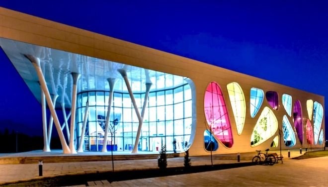 Bahadir Kul Architects, kayseri ice rink, ice rink, blob-shaped windows, turkey, kayseri, anatolian wonderland, tourism hub, mezzanine level, colorful windows, futuristic facade
