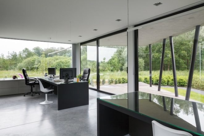 office nete, wil-ma, wastiau, floor to ceiling windows, open plan, grote nete, westerlo, flooding, stilts, steel stilts, modern building, belgian architecture, dark brick, glazing,