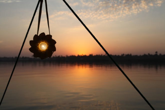 flower-shaped solar light in front of a sunset