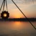 flower-shaped solar light in front of a sunset