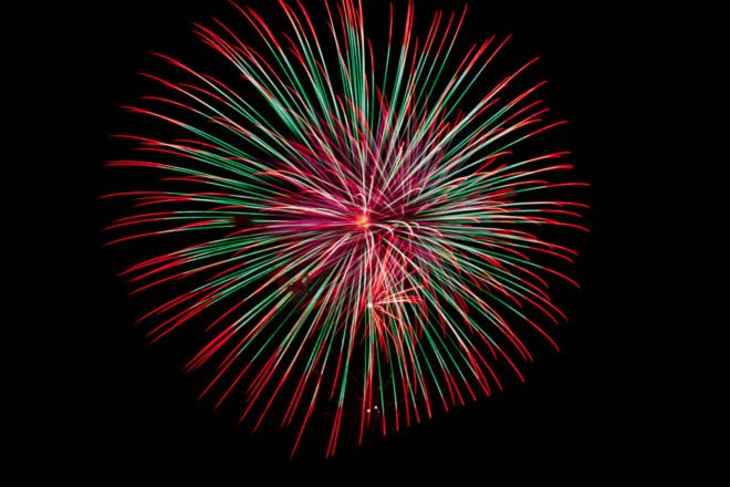 A red, white and green firework exploding