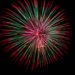 A red, white and green firework exploding