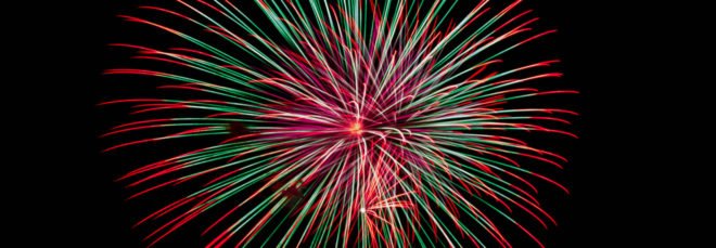 A red, white and green firework exploding