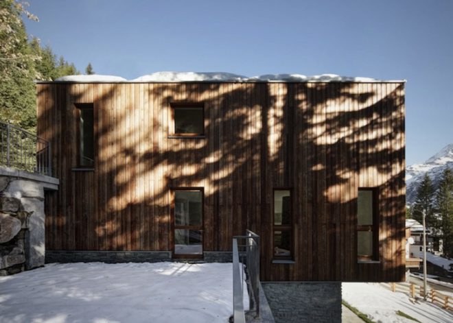 house in madesimo, ES-arch, Consalez Rossi Architetti Associati, zinc roof, lopsided roof, asymmetric roof, Rheinzink, untreated wood, larch, precast concrete panels, guest home, Madesimo, stone passageway, gray gneiss split stone