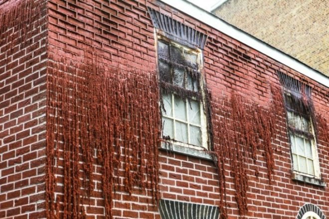 Alex Chinneck, A pound of flesh for 50p, london art, melting house, urban art london, Bankside Merge Festival, paraffin wax bricks, levitating market building,