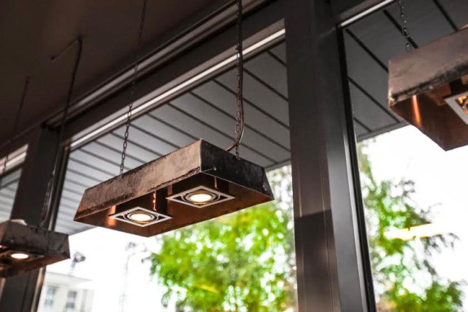 Mode:lina architekci, Doppio Cafe Bistro / Bartkowscy, sustainable renovation, polish bakery, recycled baking trays, baking trays as lamps, tradition and modernity, wooden furniture,