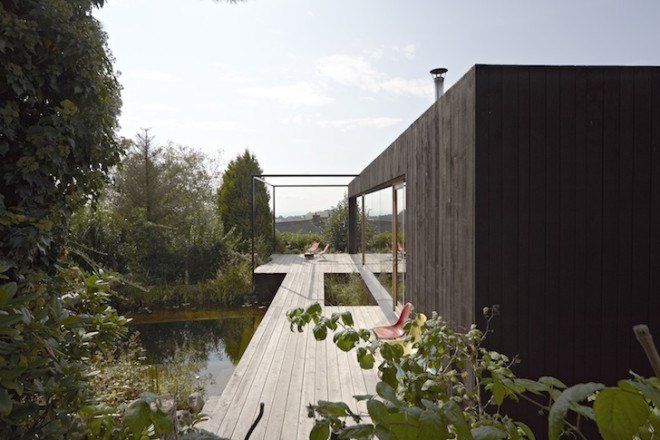 HPSA, Hammerschmid, Pachl, Seebacher Architekten, Teichhaus, spruce, Swedish mud color, Austria, Austrian architecture, natural swimming pool, elevated house, white oiled birch plywood, plywood, spruce board, gray fiberboard, open plan layout, natural light, minimal site disturbance, wooden deck
