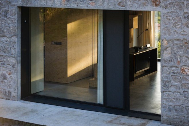 Dekleva Gregorič Arhitekti, Compact Karst House, Karst, Slovenia, Karst Plateau, stony house, monolithic architecture, contemporary architecture, untreated wood, wooden volumes, limestone, pitched roof, concrete, skylights