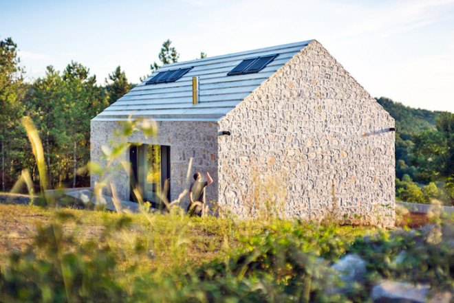 Dekleva Gregorič Arhitekti, Compact Karst House, Karst, Slovenia, Karst Plateau, stony house, monolithic architecture, contemporary architecture, untreated wood, wooden volumes, limestone, pitched roof, concrete, skylights