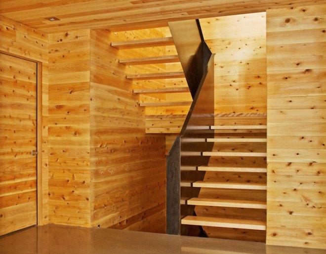 MU architects, open tread stairs, Malbaie VIII Residence La Grange, Malbaie VIII, St. Lawrence River, white cedar, dark gray metal, metal cladding, timber home, Charlevoix, outdoor terrace, barn-inspired architecture, cathedral ceiling, natural light,