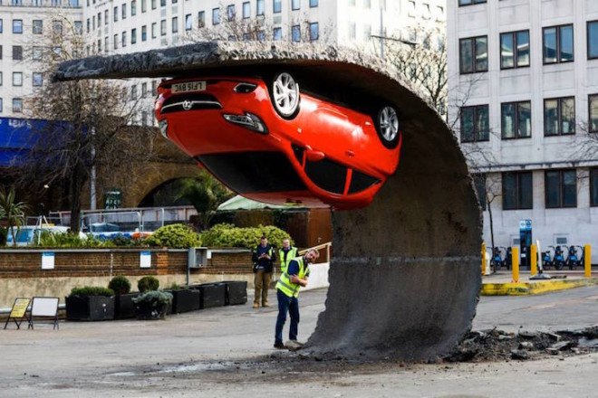 Alex Chinneck, gravity-defying artwork, art installation, ‘Pick yourself up and pull yourself together,’ Vauxhall Motors, Vauxhall Corsa, illusory artwork, tarmac, temporary art,