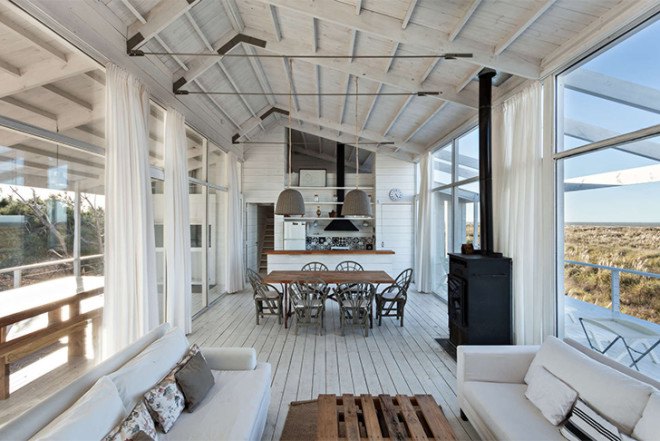Alric Galindez, RM House, house on stilts, grassy Pampas, glazed facade, natural light, Mar de Ajó, floating house