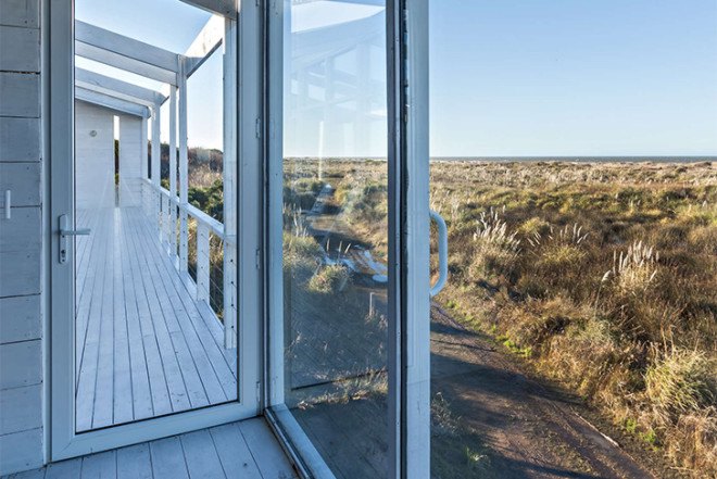 Alric Galindez, RM House, house on stilts, grassy Pampas, glazed facade, natural light, Mar de Ajó, floating house