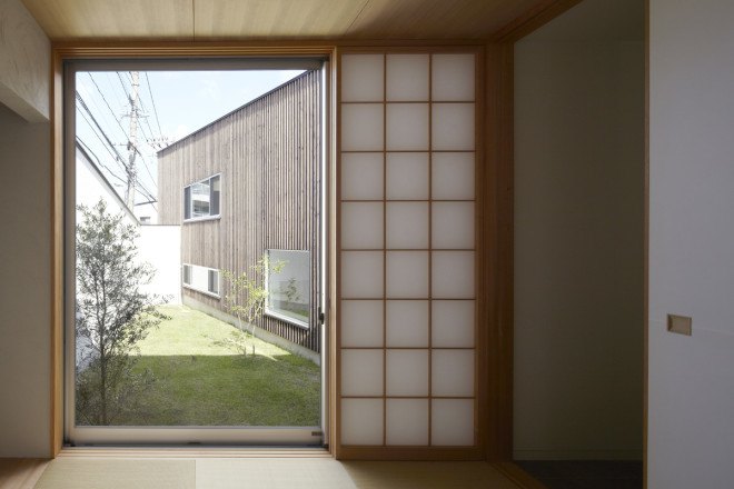 N House, N House by Roote, Roote, difficult terrain, difficult site, challenging plot of land, challenging site, timber clad architecture, timber, floor to ceiling glass doors, outdoor patio, children’s play space, Fukuoka, Japanese architecture,