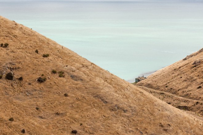 Annandale Seascape Cottage, Pattersons, New Zealand, green retreat, green cottage, rainwater harvesting, reforestation, earthquake-resistant home, glass facade, seaside home