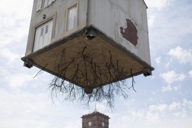 pulled up by the roots, leandro erlich, karlsruhe germany, a city of stars, a city of stars festival, construction art installation, house with roots, house suspended in air, house art exhibit, house art installation