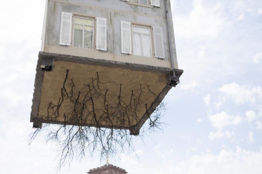 pulled up by the roots, leandro erlich, karlsruhe germany, a city of stars, a city of stars festival, construction art installation, house with roots, house suspended in air, house art exhibit, house art installation